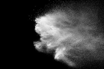 White talcume powder explosion on black background. White dust splashing.
