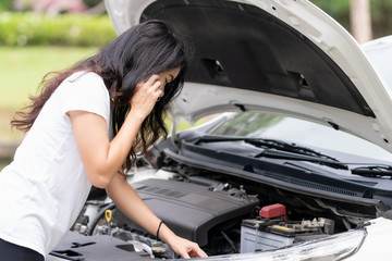 Fototapeta na wymiar Young woman is calling to car mechanic to repair broken car.