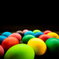 Variety of painted Easter eggs on black background