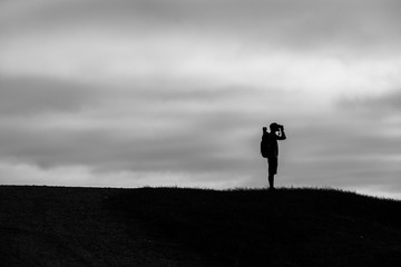 silhouette of man on top of mountain