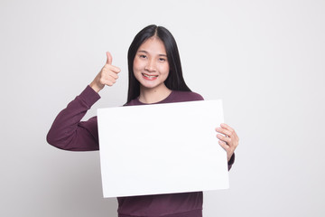 Fototapeta premium Young Asian woman show thumbs up with white blank sign.