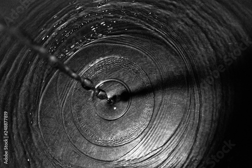 Drops Of Water Drip Out Of The Tap And Sink And Create Waves