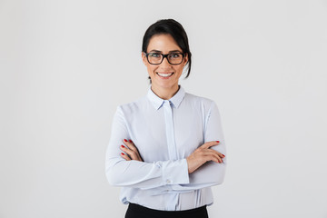 Photo of pretty businesslike woman wearing eyeglasses standing in the office, isolated over white...