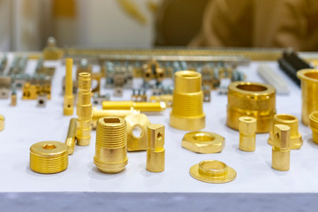 many type and various of industrial casting and machining parts gold color or brass on table as thread screw connection joint nut bolt washer etc.