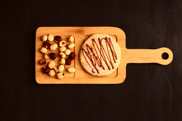 nut cookies and hazelnuts on a wooden board.