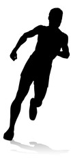 Fototapeta premium Silhouette runner in a race track and field event
