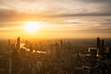 Panorama of Bangkok city river curved skyline with sunset light.