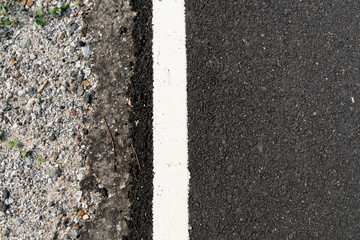 Asphalt road side corners with white border lines