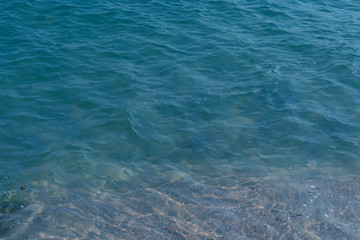 Clear sea water overlooking the sandy beach on the south side.