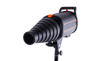 Flash tube strobe close up. Pulse studio flash with a conical snoot on a stand isolated white...