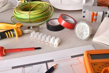 Office desk of electrical engineer with project and tools elevated