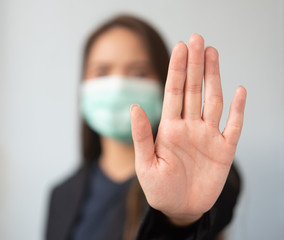 Women wearing dust masks Use the hand to display anti-symbols and prohibit ready to stop