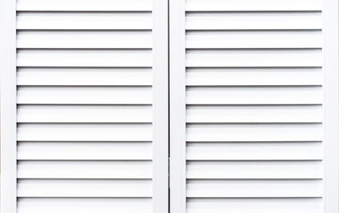 White wooden shutters to protect windows from sunlight.