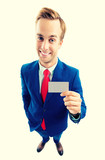 Businessman showing business or plastic card, with copyspace