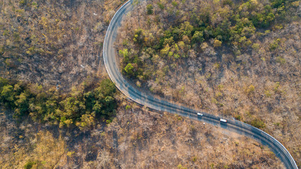 Road curve aerial view in forest  above shoot with Drone