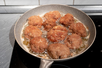 Close up photo of fried meatballs in a pan