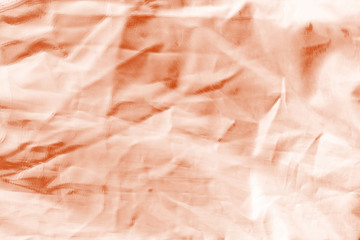Fototapeta premium Elegant orange textile background. Silk cloth texture. Fabric pattern.