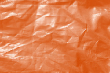 Elegant orange textile background. Silk cloth texture. Fabric pattern.