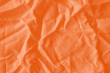 Elegant orange textile background. Silk cloth texture. Fabric pattern.
