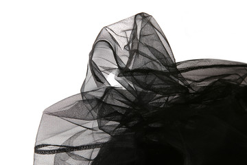 Abstract composition of black tulle material  isolated on white background. Waving shape of tulle fabric with copy space.