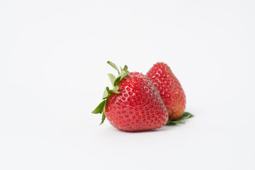 Two red strawberries On the white background