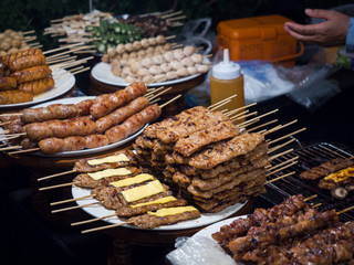 Grilled pork top cheese with sweet sauce, Thai style sausage on plate in street food
