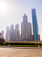Fototapeta na wymiar Streets with modern skyscrapers of the city of Dubai.