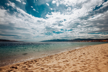 Sandy beach and a cloudy sky.