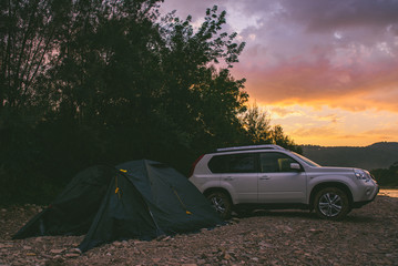 camping at rivershore on sunrise. white suv car © phpetrunina14