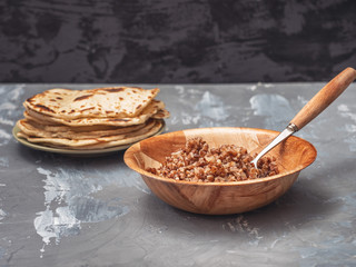 Vegetarian lunch, a plate of buckwheat porridge with freshly baked homemade cakes