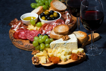 cheese platter, bread, fruit and cold cuts to wine