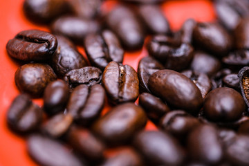 roasted coffee beans on red background
