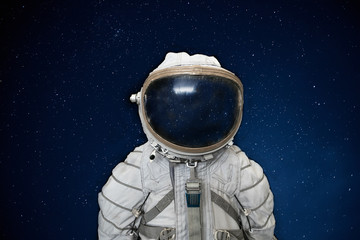 Soviet cosmonaut or astronaut or spaceman suit and helmet on black space with stars background © DedMityay