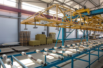 Fototapeta premium Automatic conveyor machinery line or belt for metal roll forming in industrial factory interior as industry background