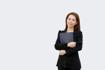 Naklejka premium Asian business woman holding folder and smiling at camera in black suit isolated on white color background