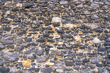 Black stone old ancient wall background with copy space. Abstract old close-up texture. Patterned view.