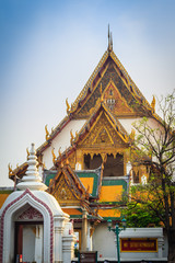Fototapeta premium Beautiful roof gable and entrance gate of Wat Suthat temple, Thailand. Wat Suthat Thepphawararam is a royal temple of the first grade in Bangkok. Construction of the temple was completed in 1847.