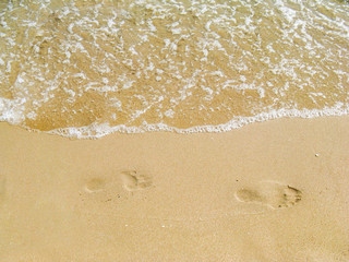 The sea transparent clear wave gradually washes away traces on the sand left by happy people having a rest. Walk along the promenade with the cleanest sea air.
