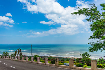 Fototapeta premium Awesome view of sea beach & blue sky scenery from a resort hotel parking road.