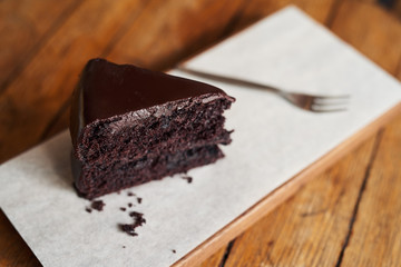 Delicious piece of chocolate cake sitting on a cafe table