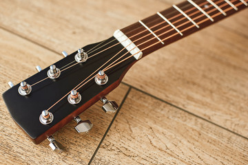 Uppermost part of the guitar. Close view of guitar headstock with tuning keys for adjusting guitar...