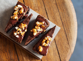 Slices of chocolate cake sitting on a bakery serving board