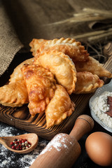 Homemade pies with cabbage on a wooden rustic  table