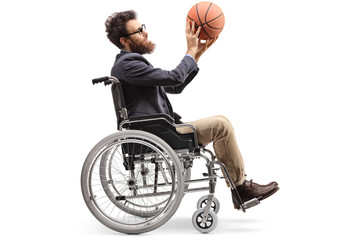 Young man in a wheelchair holding a basketball