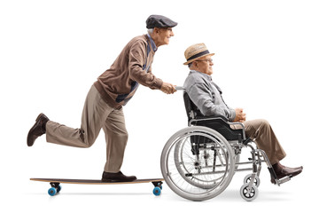 Elderly man pushing a man in a wheelchair