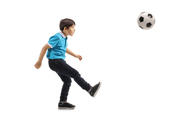 Fototapeta premium Little boy kicking a soccer ball