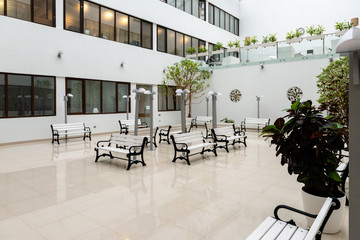 Modern large waiting room with white benches