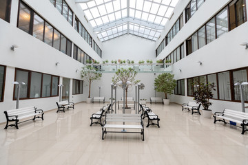 Modern large waiting room with white benches