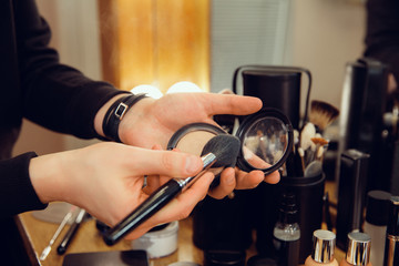 Professional makeup artist working at salon. The man in female proffesion. Gender equality concept....