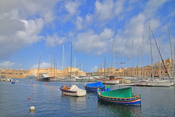 Fototapeta premium Traditional Maltese boats moored in the harbor of the island.